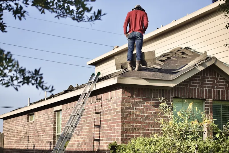 Professional roofer working on a residential roof in Boalsburg